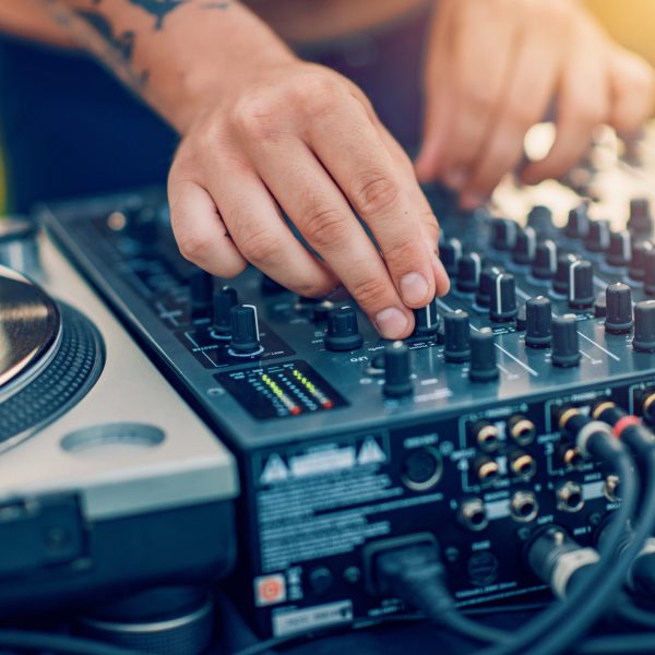 DJ at work.Close up of dj playing music on pool party.